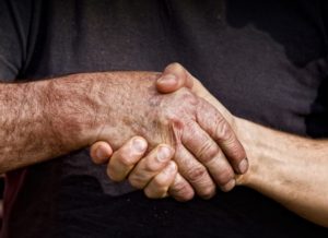 Close up of two male worker's hands making deal